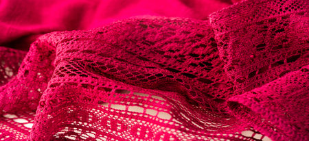 red lace fabric, red lace patterned with flower shape on a white background. background texture, pattern.の写真素材