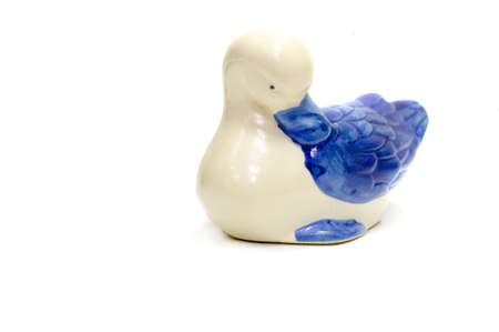 Figurine of a swan. ceramics porcelain. Flea market. Folk crafts Gzhel, Small size. Macro photography. isolated on white backgroundの写真素材