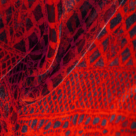 red background from textile material. lace fabric. Natural ruby texture. Texture, background,...