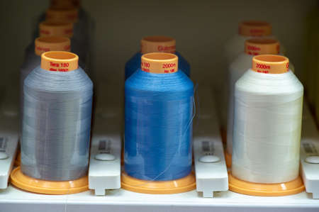 A thread is a continuous strand (made of fibers or threads twisted together), a long, thin strand of cotton, nylon, or other fibers used in sewing or weaving. 20 11 2020 Russia Chelnyのeditorial素材