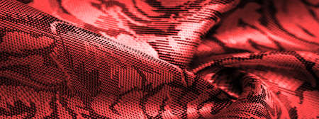 red silk fabric with flower pattern, beautiful appearance, unique shine; embossed pattern, composite textile. relief patternの写真素材