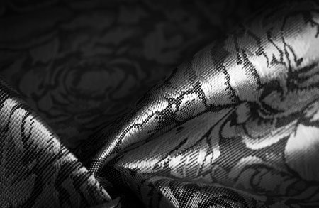 black silk fabric with a floral pattern, unique shine; embossed pattern, composite textile. relief patternの写真素材