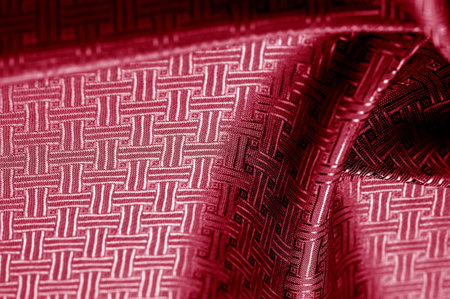 Red silk fabric with a fine checkered pattern. Background texture, pattern.の写真素材