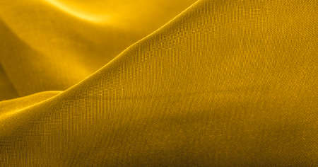 Yellow silk fabric. Very lightweight viscose fabric with a pleasant shine. Perfect for adding elegance to your online projects. texture background, patternの写真素材