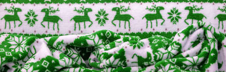 Velvet. Plush. For winter wear. Snow deer, snowflakes. Green and white tones. Silk fabric with soft, smooth and thick pile. Rich silk clothの写真素材
