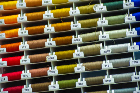 A thread is a continuous strand (made of fibers or threads twisted together), a long, thin strand of cotton, nylon, or other fibers used in sewing or weaving. 20 11 2020 Russia Chelnyのeditorial素材