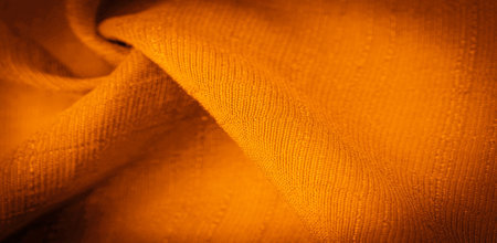 Brown and yellow fabric, dark amber silk, bright sunny abstract background illustration. Decorative items close-up. Wallpaper texture, backgroundの写真素材