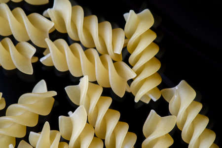 Short pasta. Fusilli, commonly known as rotini in the United States, is a variety of pasta that has a corkscrew or spiral shape. The word fusilli is believed to be derived from fuso ("spindle").の写真素材