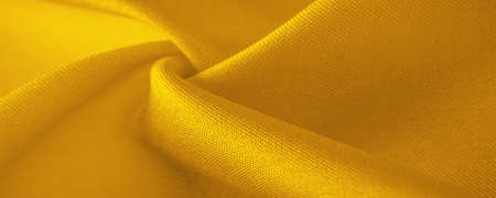 yellow silk fabric, beautiful smooth elegant wavy yellow satin silk luxury fabric, abstract design. background texture, patternの写真素材