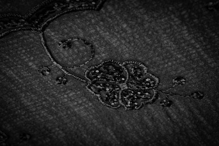 Silk black. The fabric is embellished with sequins. background, silk satin, luxurious texture, dark fabric, costume cotton material, abstract color image pattern, delicate liquid charcoal velvetの写真素材