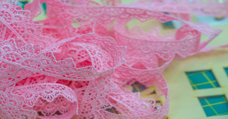 The lace ribbon is pink. This ribbon is perfect for adding fun style or modest traditional...