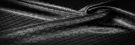 Black silk fabric with a fine checkered pattern. Background texture, pattern.の写真素材