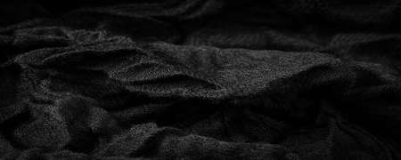 Black rough woolen fabric. Sheep with long, durable, coarse-fiber wool, especially suited to your design. As with various large breeds of lamb of English origin. Texture background patternの写真素材