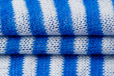 White and blue stripe fabric. Knitted fabric is a fabric that is obtained as a result of knitting, the process of weaving threads or weaving loops.の写真素材