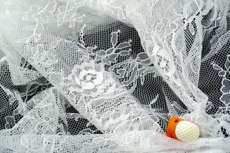 White lace fabric. Vintage floral background. white vintage old floral lace on black backgroundの写真素材