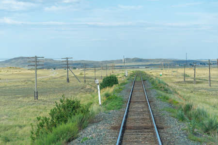 railway, railroad, rail, elevated. steppe.- is a means of transportation and passengers of trucks moving on rails that are located on the rails of the Great Plains. Kazakhstan The steppe is great.の写真素材