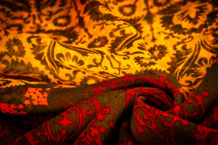 Silk brown with floral print and rhombuses. Soft fabric, glossy texture background, satin background, fabric luxury work, elegant pattern, colorful abstract, colorful velvet, macro shredded.の写真素材