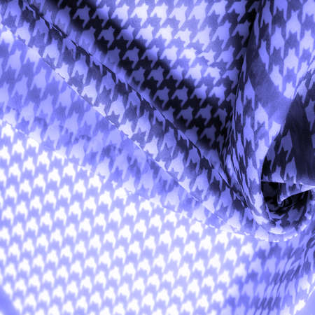 Delicate blue silk chiffon in vibrant colors with geometric print. Surprisingly light, smooth, sandy to the touch fabric. texture.の写真素材