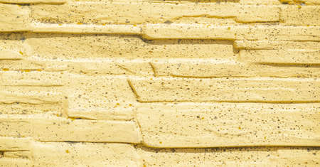 The stone on the fence is painted with yellow paint. A fence is an important visual element that separates your space from someone else's. Height, material, colorの写真素材