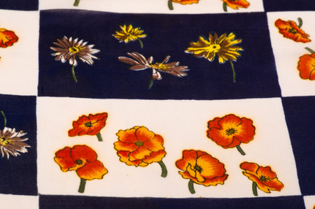 Silk fabric. White and blue squares with floral print. The flowers are red-yellow. Texture...