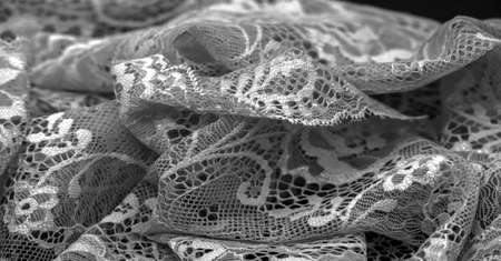 Black lace. Vintage floral background. Lace is an openwork fabric obtained by crossing the threads that form motives connected by the baseの写真素材