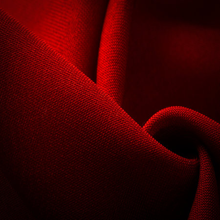 Satin Red Silk is a weave that usually has a glossy surface and a matte back, a satin weave is characterized by four or more fillers or weft threads.の写真素材