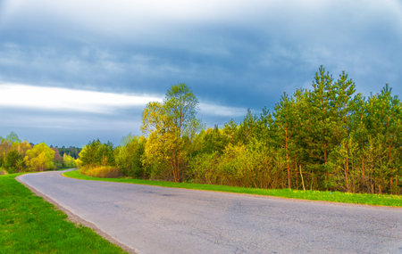 The Sun is rising. Sunsets. Over the forest. Provincial road. Central strip of Europe. Spring time of the year. sunrise, rise, uprise. decline, afterglowの写真素材