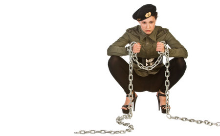 Sexy Asian girl in military uniform with white big iron chain. Girl flirty posing in front of the cameraの写真素材