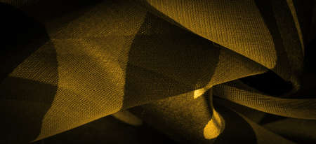 silk fabric in abstract yellow colors. Abstract watercolor paint, painted textured vertical silk fabric, canvas, macro, close-up. Texture. Background. Template.の写真素材