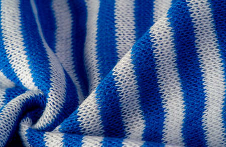 White and blue stripe fabric. Knitted fabric is a fabric that is obtained as a result of knitting, the process of weaving threads or weaving loops.の写真素材