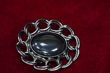 Women's brooch. Accentuate classic glamor with our edition of women's brooches. Embodying elegance, these designer brooches are detailed with crystals, logo fittings and colorful gems.の写真素材