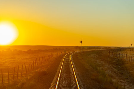 railway overpass. steppe. Railway landscape at sunrise. Summer sunny day. Sunset. dawn over the railroad tracks.の写真素材