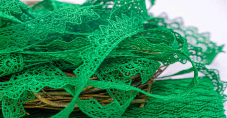 Green lace ribbon. Thick elastic lace ribbon with floral trim for design, craftwork and gift wrappingの写真素材
