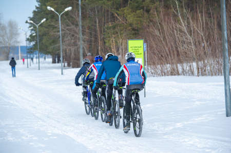 An active lifestyle. Snowboard. bike, skis. race walking. Snow covered the ground. Sunny day. Soon the warm spring sun will melt the winter snows. Russia Naberezhnye Chelny 7 03 2021のeditorial素材
