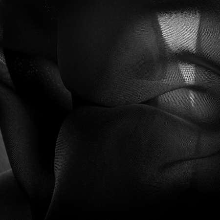 Satin Black Silk is a weave that usually has a glossy surface and a matte back, satin weave is characterized by four or more fillers or weft threads.の写真素材