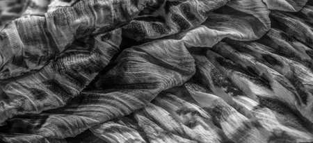 Silk fabric in fine organza with panther print, black and white. Crumpled texture. Background. Template.の写真素材