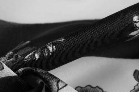 Silk fabric. Black and white squares with floral print. The flowers are black and white. Texture background pattern. From the floral print, the fabric breathes in spring and good mood.の写真素材