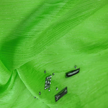silk pattern, green fabric with glued decorative faceted stonesの写真素材