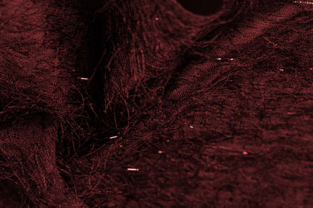 Red silk fabric in burgundy color with sequins and yarns on the surface of the fabric. This ombre tulle in red with abstract embroidery, embellished with sequins and yarns from a European designerの写真素材