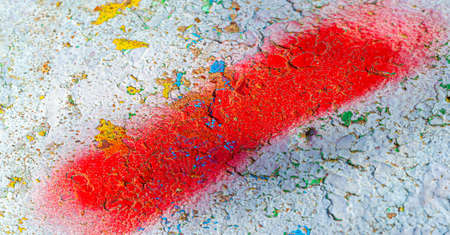 Old flaking paint, bright colored spots on the concrete pavement from old paint. Grunge texture backgroundの写真素材