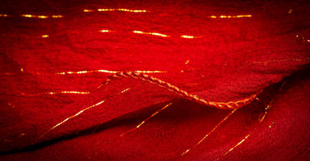 Red silk fabric with lurex. Glossy texture background, satin background, luxurious fabric, elegant pattern, colorful abstract, colorful velvet, shredded macro.の写真素材