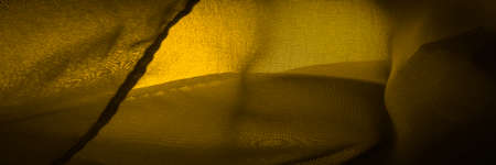 satin yellow sepia is a weave that usually has a glossy surface and a dull back, Satin weave is characterized by four or more filler or weft threadsの写真素材