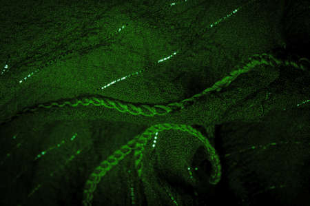 Green silk fabric with lurex. Glossy texture background, satin background, luxurious fabric, elegant pattern, colorful abstract, colorful velvet, shredded macro.の写真素材