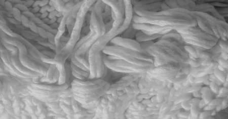 White knitted wool scarf. Large chunky knit. Gorgeous winter handmade wool scarf - Deep snow band - Warm soft white for the neckの写真素材