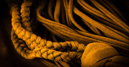 Fabric in yellow braids. Knitted knitted background with embossed pattern. Braids in knitting.Texture background patternの写真素材