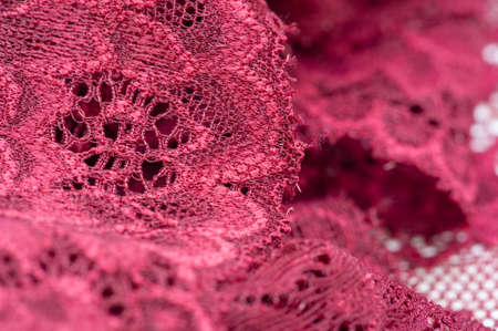 red lace. Elastic fashionable textile jacquard lace. Decorative item for sexy lingerie. elastic tapes. Home decor. Texture for your design. background. template.の写真素材