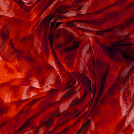 Red cloth. Silk fabric in fine organza with panther print, Crumpled texture. Background. Template.の写真素材
