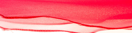 Red silk folded fabric background, banner or cover design. luxurious textile decoration backdrop for poster, Scarlet drapery material with soft satin waves, poster Texture. Background. Pattern.の写真素材