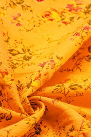 Yellow orange cotton fabric with floral print. Buy floral prints from independent artists and iconic brands. Texture, background,の写真素材