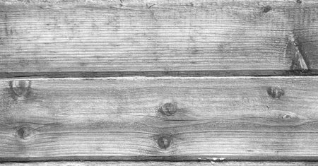 The texture of the old tree, the timber from which the house was built. Deep cracks are visible on...